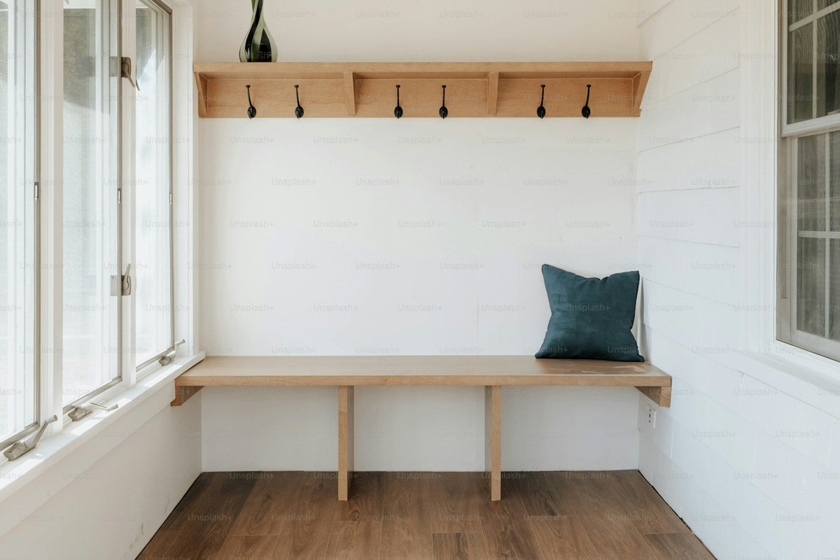 Warm wooden bench beside a naturally lit window